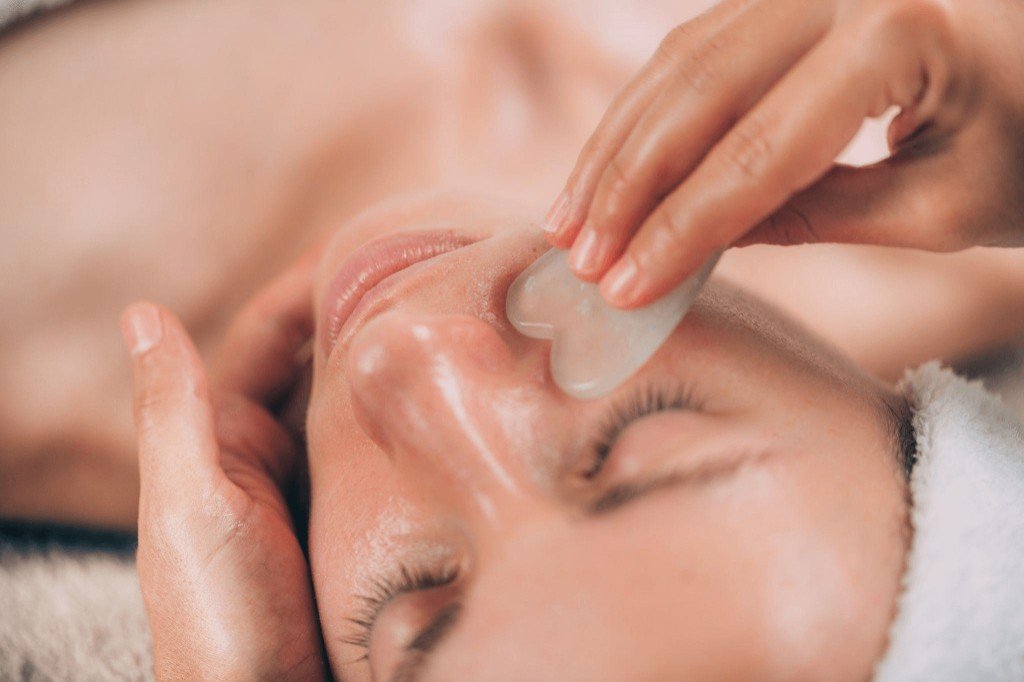 Gua Sha facial massage with stone tool